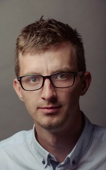 Portrait of a smart serious young man.