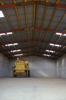 combine harvester standing ready for harvest in a warehouse