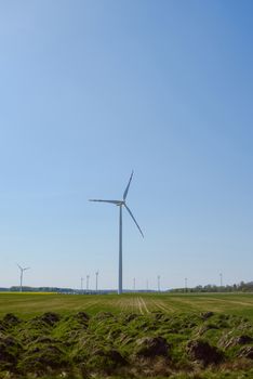 Bright blue sky moving and wind turbine.