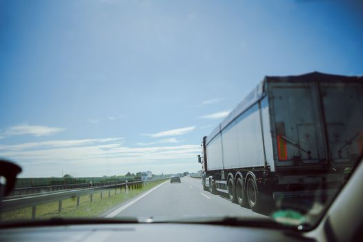 traffic on the freeway with cars and trucks overtaking.