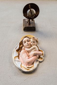 Religious icon. On stone wall of Virgin Mary and the holy child Jesus