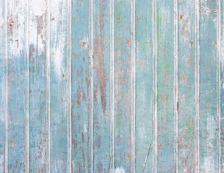 Closeup shot of an old blue wooden door texture. Wood background.