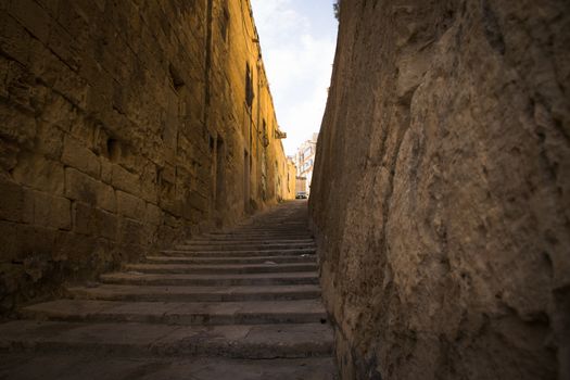 typical narrow street with stairs in the city Valetta on the island of Malta