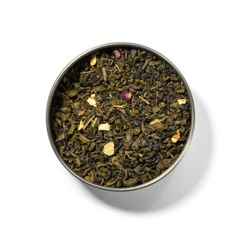 Green tea with aromatic additives. Top view on white background.