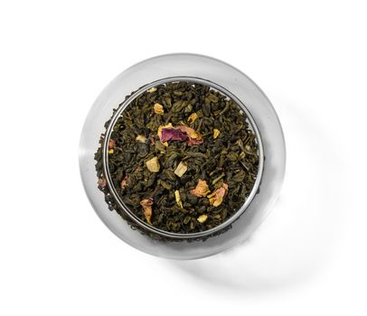 Green tea with aromatic additives. Top view on white background.