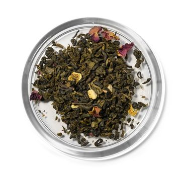 Green tea with aromatic additives. Top view on white background.