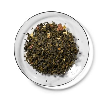Green tea with aromatic additives. Top view on white background.