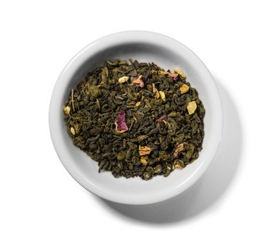 Green tea with aromatic additives. Top view on white background.
