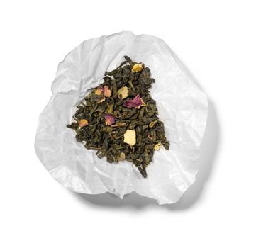 Green tea with aromatic additives. Top view on white background.