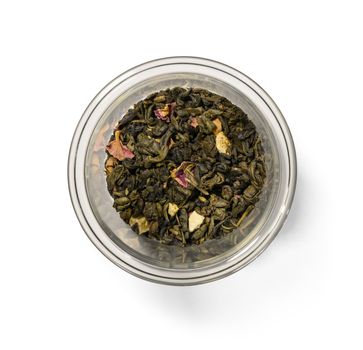 Green tea with aromatic additives. Top view on white background.