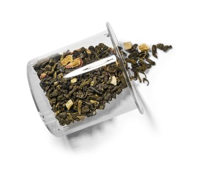 Green tea with aromatic additives. Top view on white background.