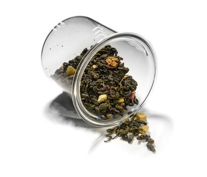 Green tea with aromatic additives. Top view on white background.