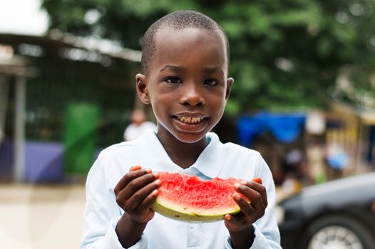 the little boy is very happy to have a watermelon eating.