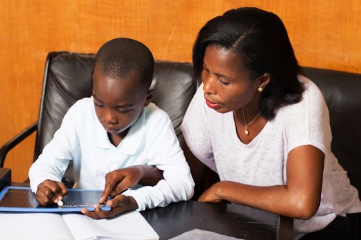 young mother teaches her child at home.