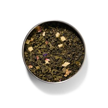 Green tea with aromatic additives. Top view on white background.
