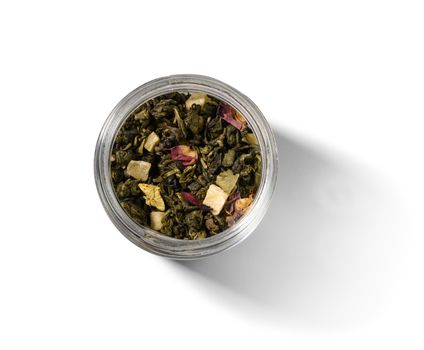 Green tea with aromatic additives. Top view on white background.