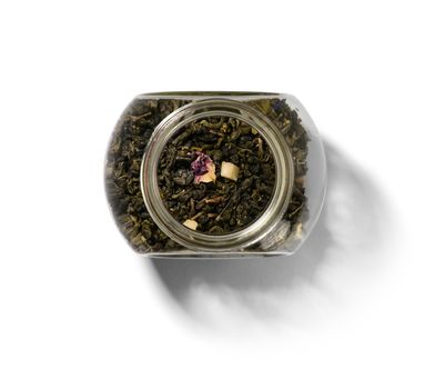 Green tea with aromatic additives. Top view on white background.