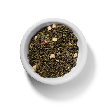 Green tea with aromatic additives. Top view on white background.