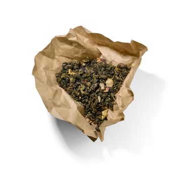 Green tea with aromatic additives. Top view on white background.