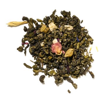 Green tea with aromatic additives. Top view on white background.