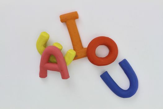 colored vowels in clay with white background