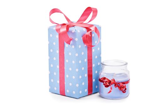 Cutely wrapped gift and candle, isolated on white background.