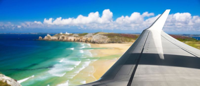a Plane flying over a beach