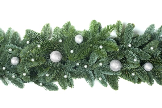 Christmas Border frame of natural noble fir tree branches and silver baubles isolated on white background