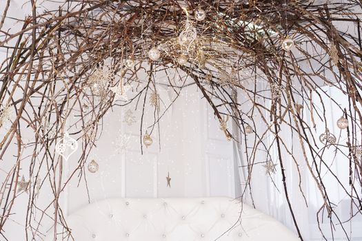 Bright white room with canopy of branches - christmas decoration at home