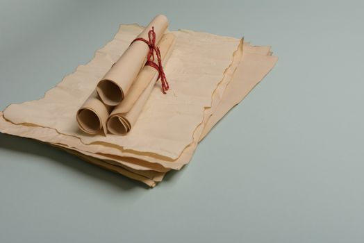 Raven feather, inkwell and old yellowed paper on red background. Copy space. Old letter.