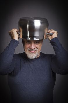 Senior gray-haired man hiding in a pot