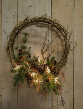 decorative wreath for Christmas with Christmas branches pine cone lights and a deer