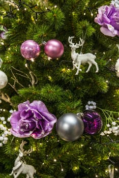 background of christmas tree with decorations in purple and silver