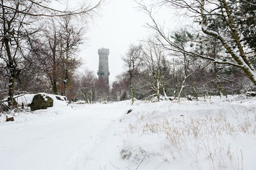 Winter landscape covered with snow and lookout tower