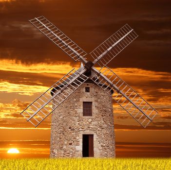 an Ancient Windmill at sunset