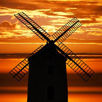 an Ancient Windmill at sunset