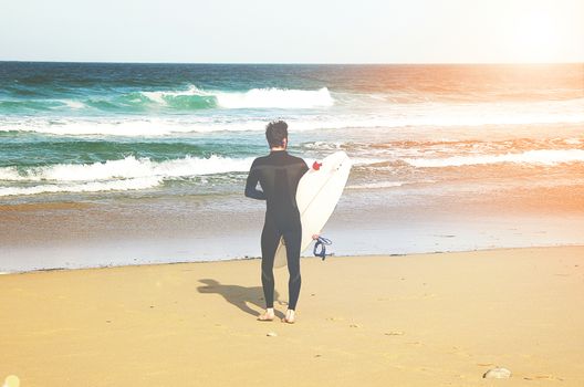 A surfer on the beach