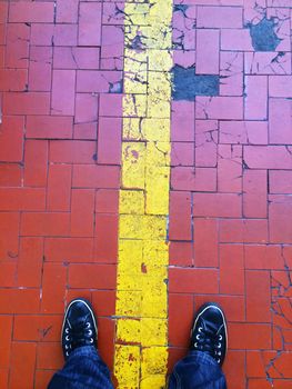 standing on a floor of red tiles