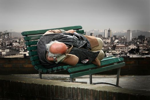 a vagabond sleeping on a bench
