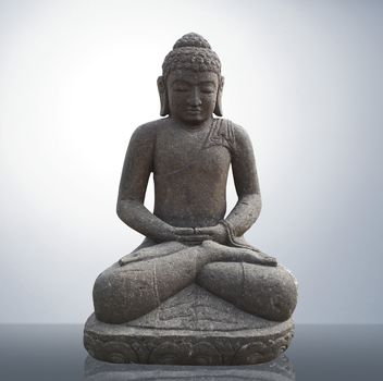 Statue of Buddha on gray background