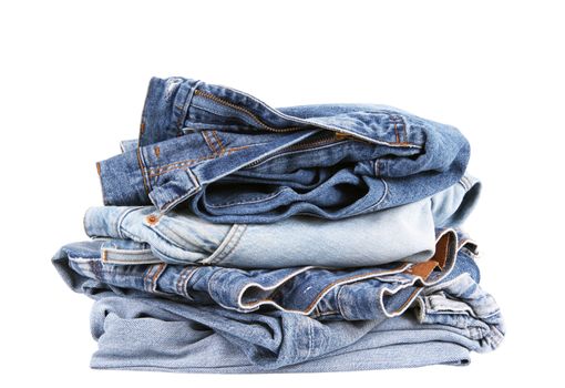 Jeans pants stacked on white background