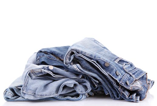 Jeans pants stacked on white background