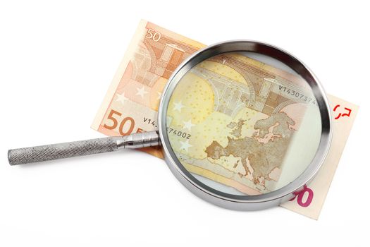 Money under magnifying glass on white background