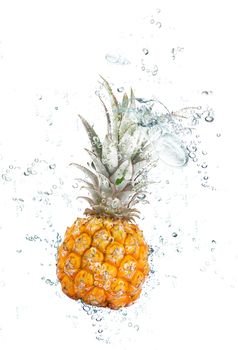 fresh pineapple falling in water