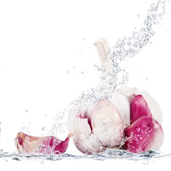 Fresh garlic falling in pure water
