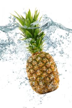 fresh pineapple falling in water