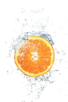 fresh orange falling in water