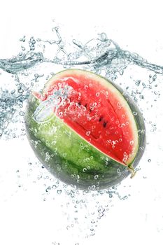 fresh watermelon falling in water