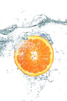 fresh orange falling in water