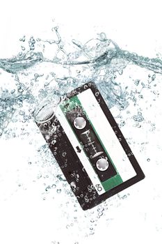 old audio cassette falling in water